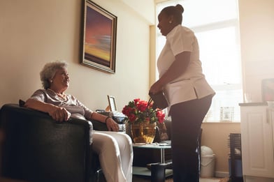 senior-woman-at-home-with-female-caregiver-PQP4YA9-min